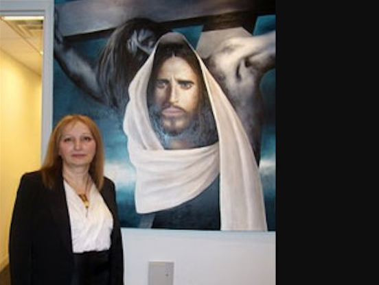 Gulnara Tsiklauri at her painting "Jesus Christ". Credit to Progress News