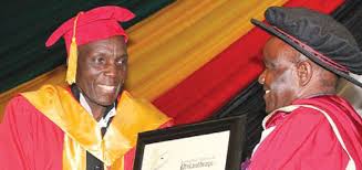 Prof. Boniface Chibore (right) gives an honorary degree to Oliver “Tuku” Mtukudzi (left). Credit: Zimbojam