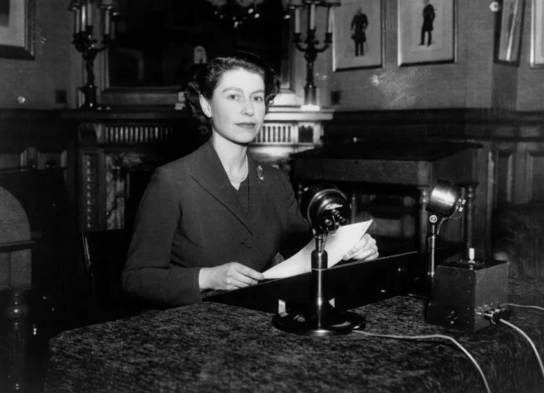 Queen Elizabeth II making her first ever Christmas broadcast to the nation from Sandringham House, Norfolk, on 25 December 1952. Credit to Getty Images