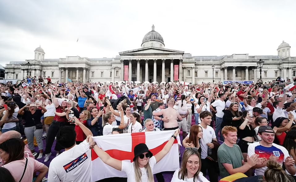 Fans celebrate the final whistle in Trafalgar Square with cheers for England's Lionesses. Credit to AP