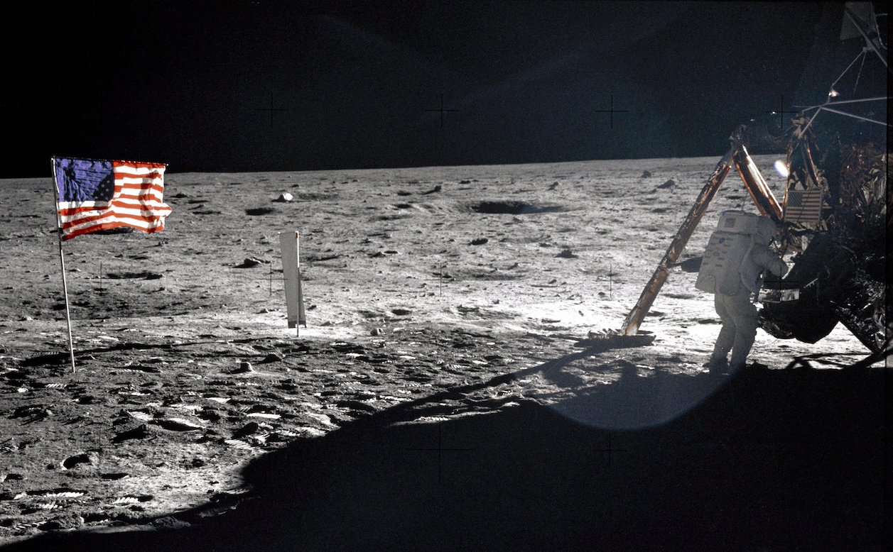 Apollo 11 Commander Neil Armstrong working at an equipment storage area on the lunar module. Credit: NASA