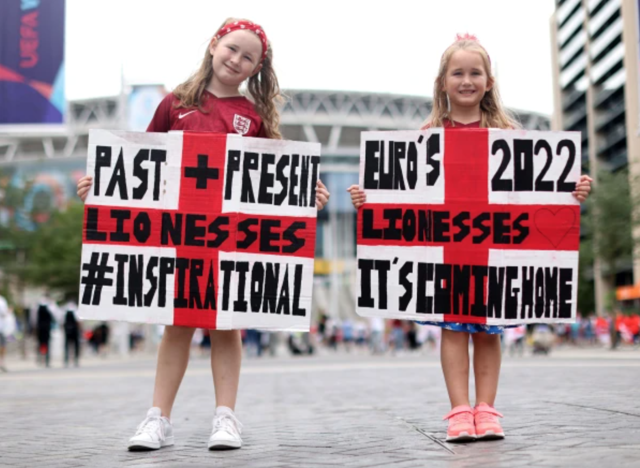 England fans Gracie May, 8, and Amelia Lee, 6, pose on Wembley Way. Credit to PA