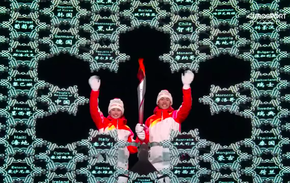 Olympians Dinigeer Yilamujiang and Zhao Jiawen with the torch. Screengrab from Eurosport