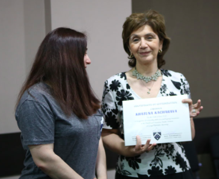 Professor Maia Nadareishvili (L) hands the Certificate and promo souvenirs&nbsp;to Professor Khatuna Kacharava (R). Credit to Mari Moseshvili/BRAMS
