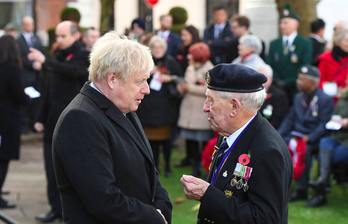 PM Boris Johnson speaks to a veteran during a service at the cenotaph in St Peter's Square on Armistice Day 2019. Credit: PA/The Standard