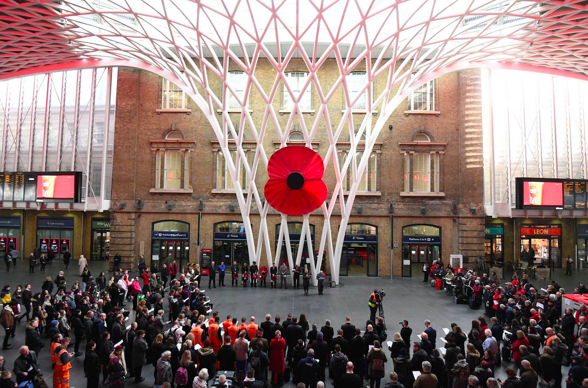 People gather in silence to mark Armistice Day at King's Cross St Pancras Station in London. Credit: PA/The Standard