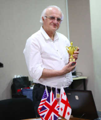 Professor Mamuka Tavkhelidze, President of GRUni, receives the BRAMS Cup from Professor Maia Nadareishvili. Credit to Mari Moseshvili/BRAMS