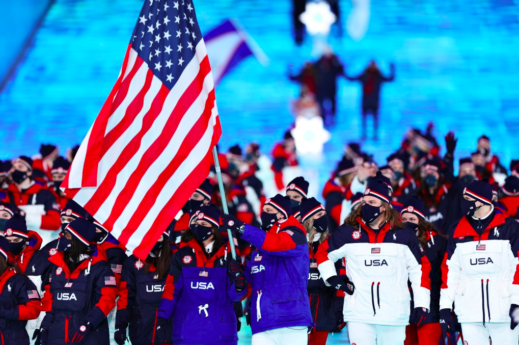 Flag bearers Brittany Bowe and John Shuster of Team USA lead the team during the opening ceremony of the Beijing 2022 Winter Olympics. Credit to Getty Images
