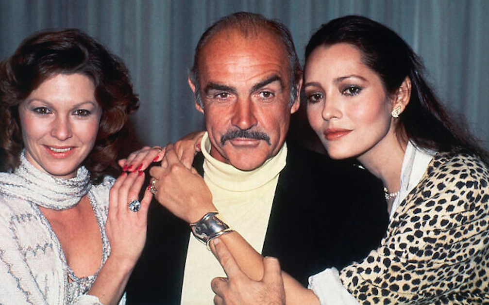 Never Say Never Again (1983) co-stars Barbara Carrera, Sean Connery, and Pamela Salem (L-R) in London on 12 December 1983. Credit to Joseph Schaber/AP