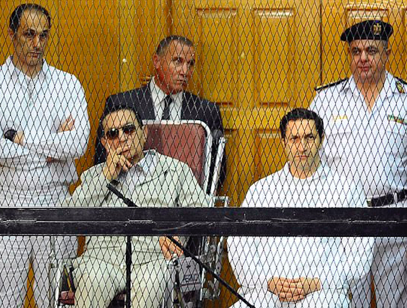 Mubarak sitting in a wheelchair as he stands trial in September 2013 for the killing of 900 anti-government protesters. Credit to Associated Press