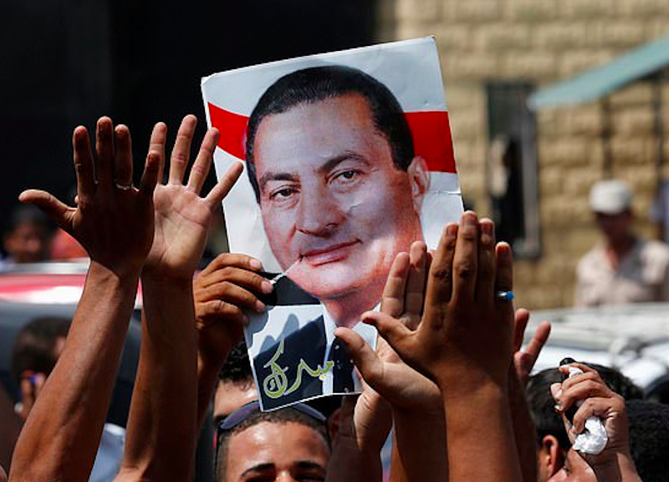 Supporters of former President Mubarak pictured protesting outside Tora prison in 2013. Credit to Reuters