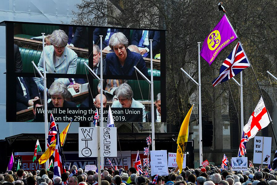 Footage of different speeches by Mrs May been played on a 50ft screen erected in Parliament Square. Credit: The Daily Mail/Reuters