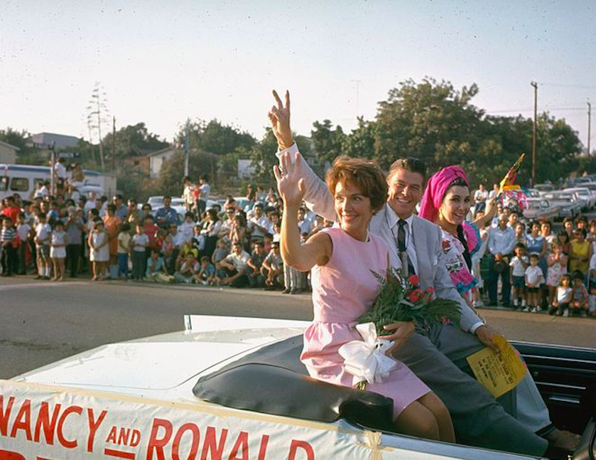 In 1966, then-California gubernatorial candidate Ronald Reagan and Nancy Reagan waved from the back of a convertible while campaigning. Credit to Bill Ray/Getty Images