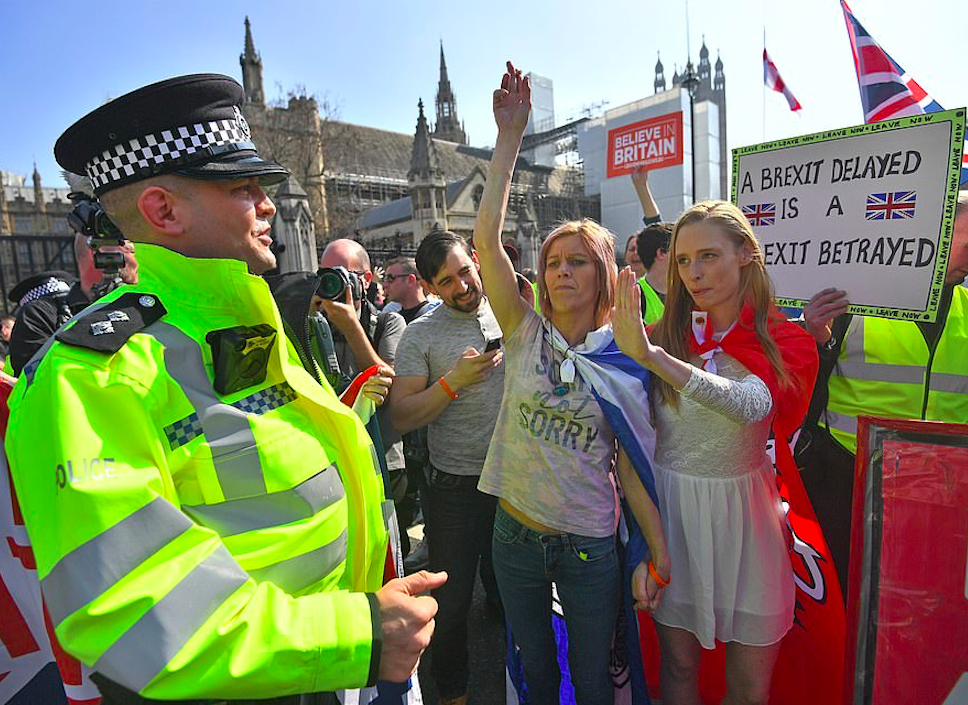 Young female Brexiteers by the gates to Westminster wearing capes of national flags. Credit: The Daily Mail/PA